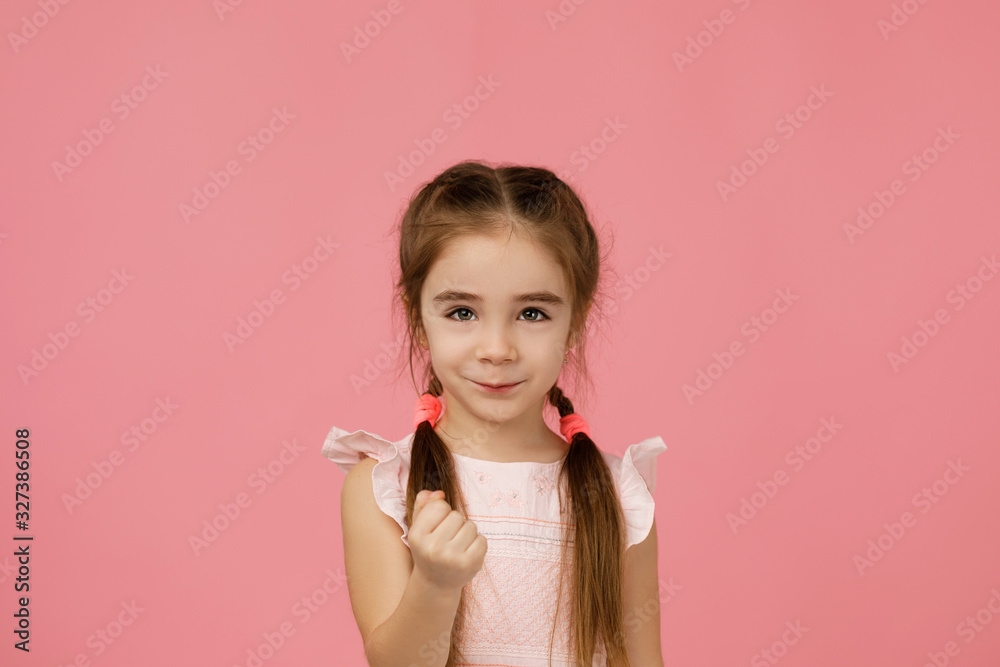 angry little child girl in dress raising fist frustrated and furious. Human emotions and facial expression angry little child girl in dress raising fist frustrated and furious. Human emotions and facial expression