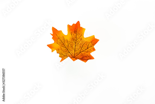 plastic artificial maple leaf made from fabric isolated on white background