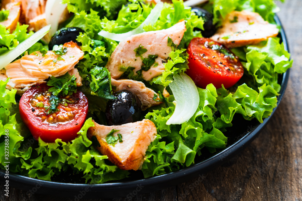 Salmon salad - roasted salmon and vegetables on wooden background Salmon salad - roasted salmon and vegetables on wooden background