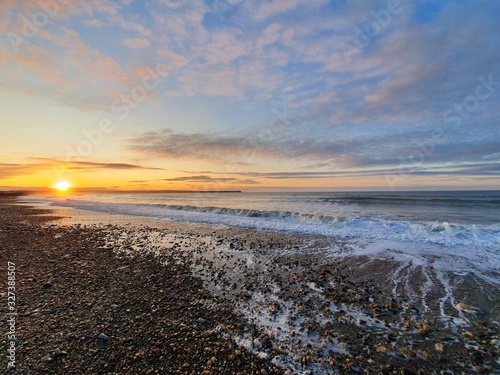 Beatiful sunrise at beach with wave tramore ireland