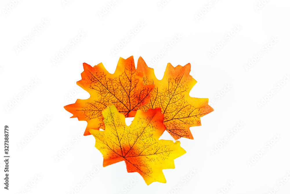 plastic artificial maple leaf made from fabric isolated on white background plastic artificial maple leaf made from fabric isolated on white background