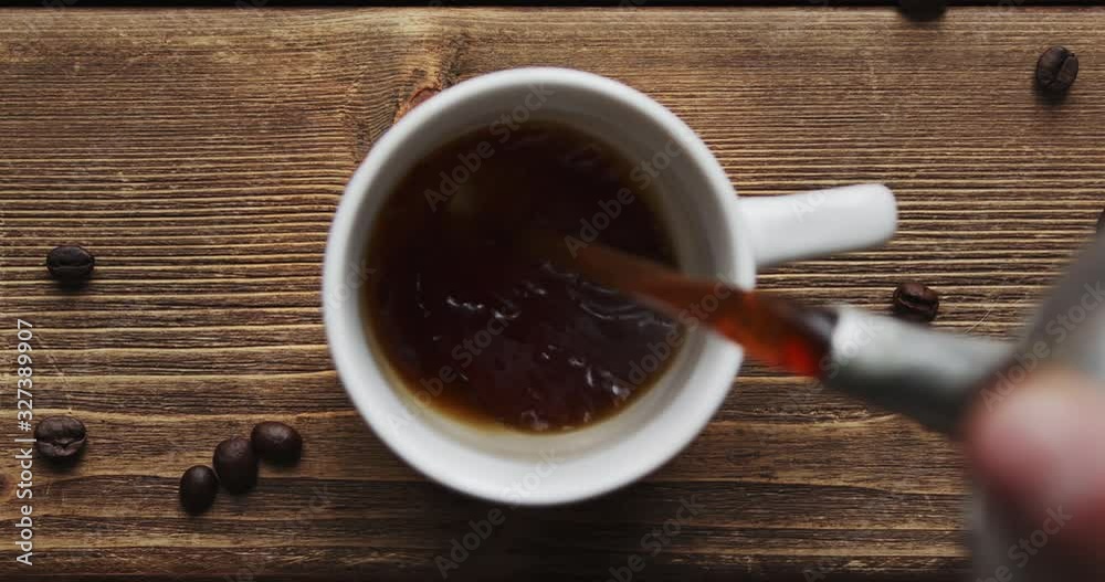 Top view of coffee pour into cup from big coffee maker