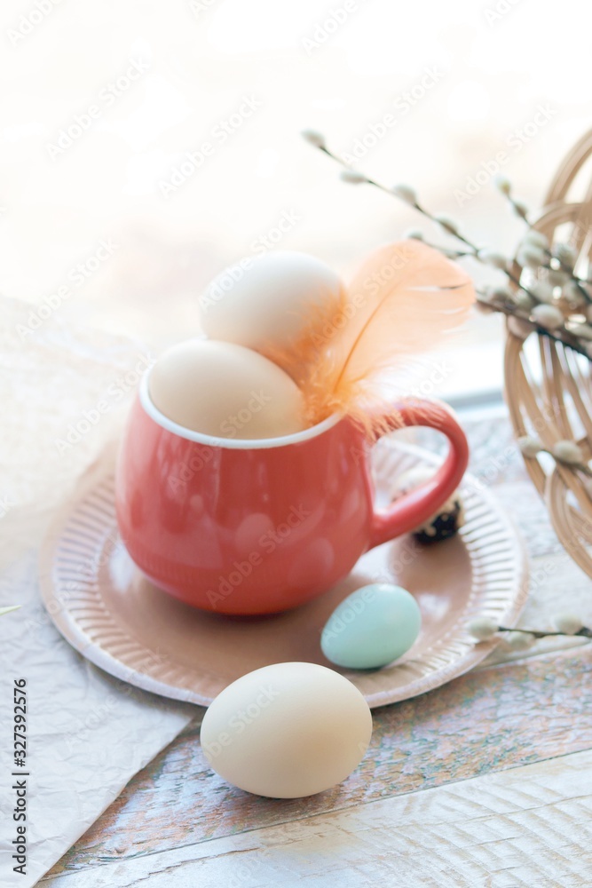 Happy Easter, a bright cup with eggs, decor, on the windowsill, interior decor for the holiday Happy Easter, a bright cup with eggs, decor, on the windowsill, interior decor for the holiday