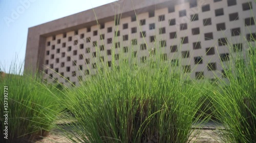 Doha, Qatar - View of blurred building in Education city with green grass foreground