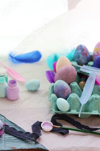 Happy Easter, eggs, paints, brushes, paper on a wooden surface, preparation for the holiday, a symbol of spring