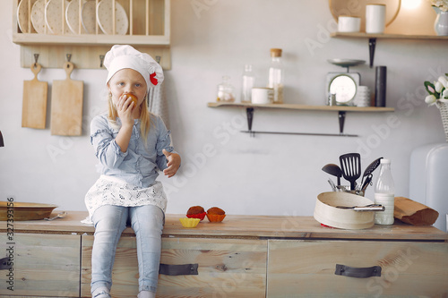 фотографія Little girl in a kitchen
