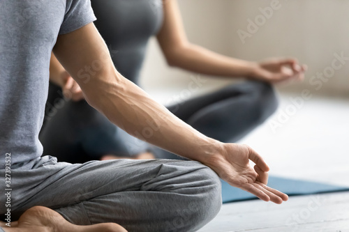 Meditation practice focus on male fingers folded in mudra symbol