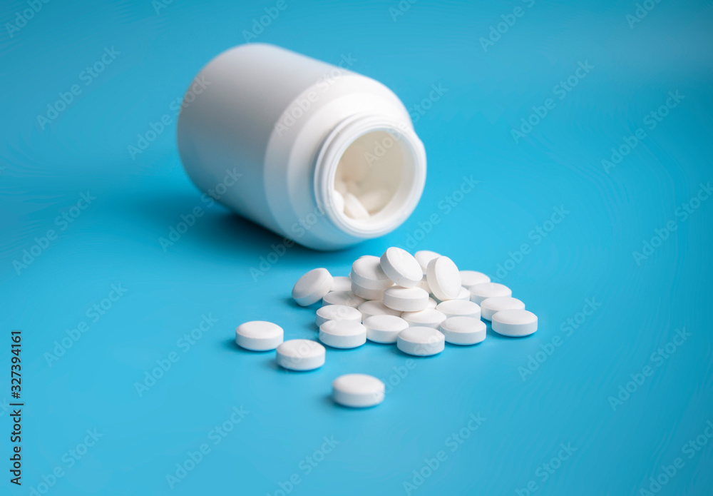 whte pills or tablets for virus on blue background whte pills or tablets for virus on blue background