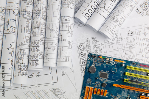 paper electrical engineering drawings and computer motherboard