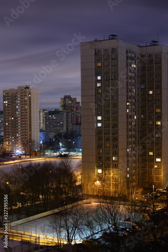 Yard stadium near multi-storey residential house in the Moscow district Konkovo at winter night on blue cloudy sky background