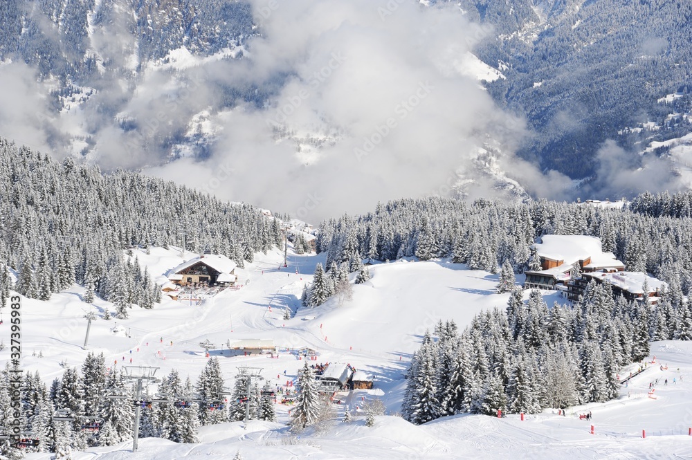 Ski resort view with clouds and snowy forest