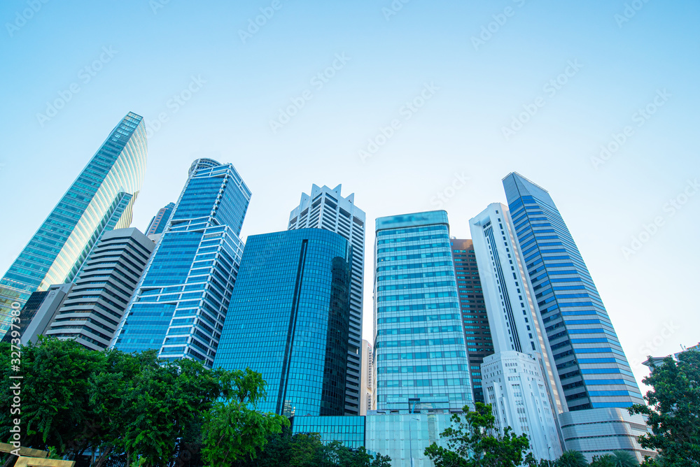 Modern business skyscrapers, high-rise buildings, architecture raising to the sky, sun. Concepts of financial, economics, future etc.