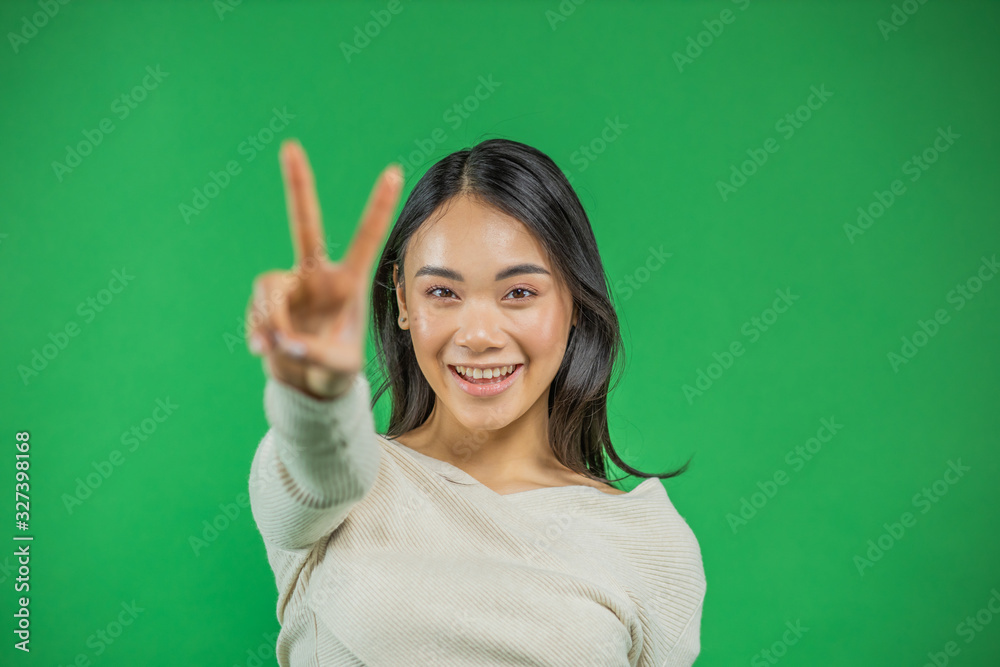 Portrait of a beautiful young asian business woman woman on green background