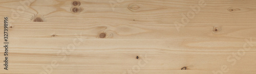 Background texture of natural spruce board with knots. Top view background banner