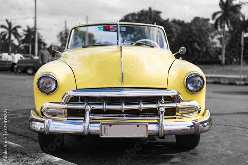 frontview colorkey of old yellow american classic car in havana cuba