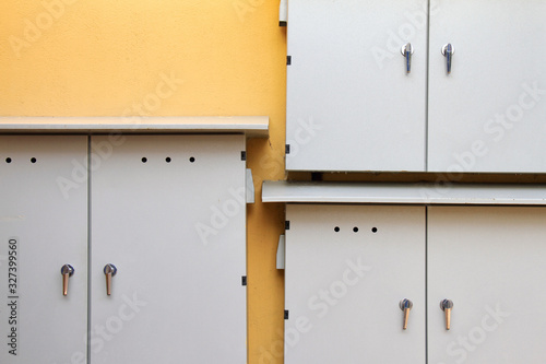 Electrical distribution control boxes on yellow wall, Power supply board, Minimal style.