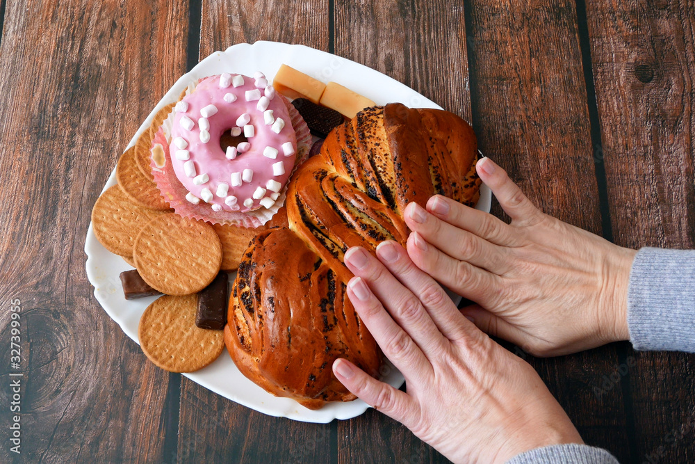 custom made wallpaper toronto digitalhands push away sweets plate with buns, candies and donut. Only healthy food concept	
