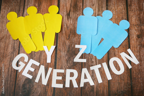 x and y generation symbol, paper models of people of different nationalities on wooden background