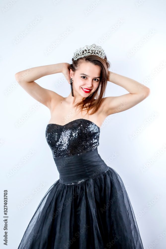 young lady posing in fashion long black dress. Portrait of a stunning young woman posing in little black dress young lady posing in fashion long black dress. Portrait of a stunning young woman posing in little black dress