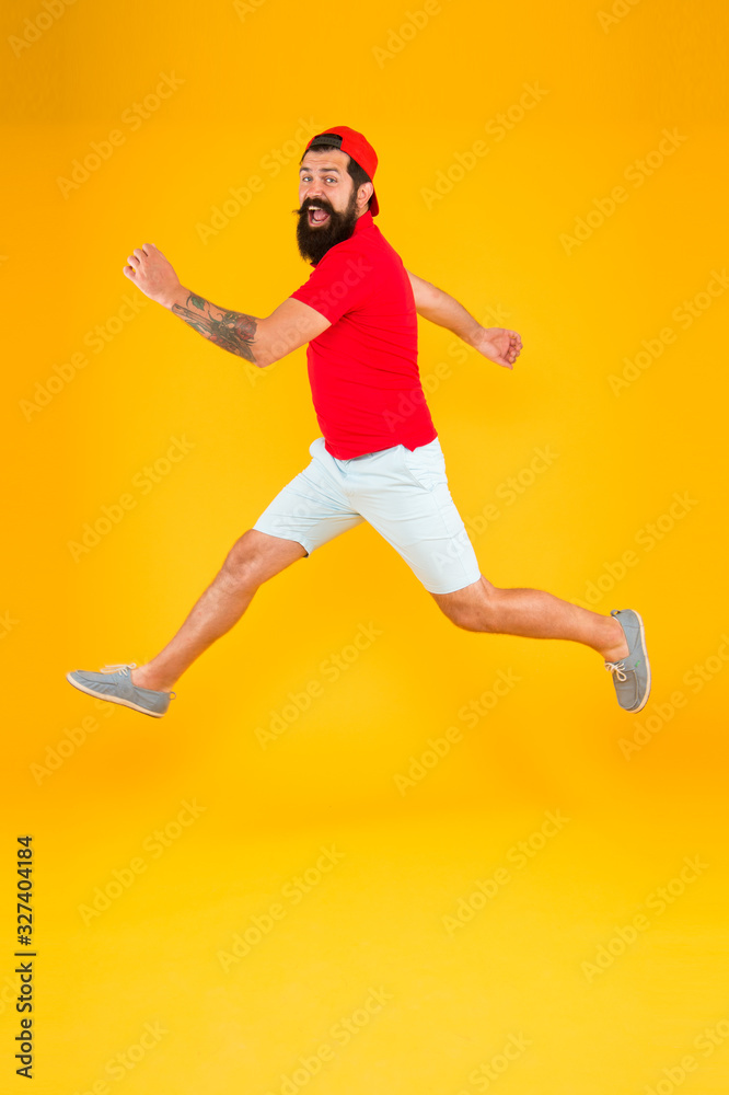 Always in motion. Enjoying active lifestyle. Happy guy jumping. Active bearded man in motion yellow background. Active and energetic hipster. Energy charge. Healthy guy feeling good. Inspired concept