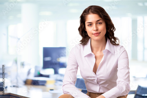 Young professional woman sitting in the office