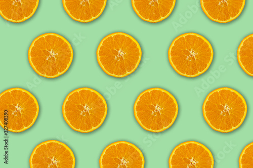 Sfondo di cibo. Vista superiore del modello colorato della frutta di fette fresche di arancia su fondo verde.