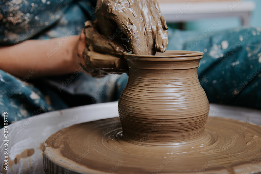 Woman hands working on pottery wheel and making a pot. Woman hands working on pottery wheel and making a pot.