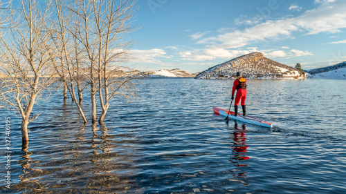 paddling stand up paddleboard in winter