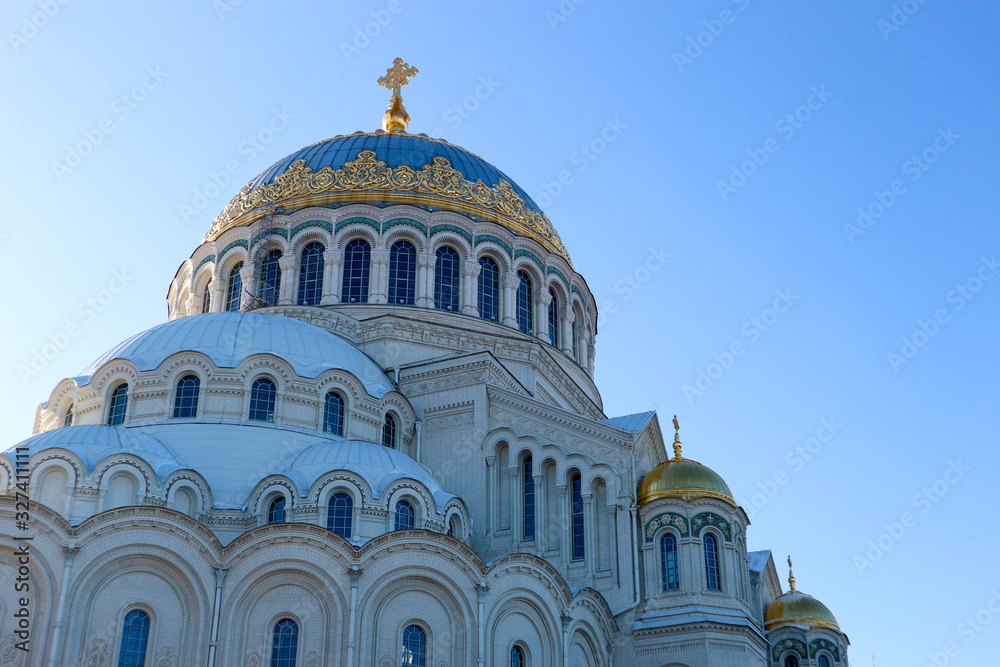 Domes of Naval cathedral of Saint Nicholas in Kronstadt, Russia against a blue sky