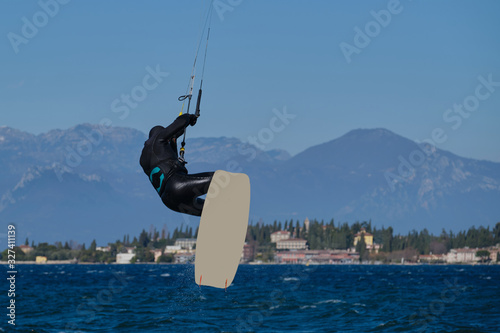 Kitesurfer in the jump on a background of high mountains, kitesurfer board with copy space for advertising