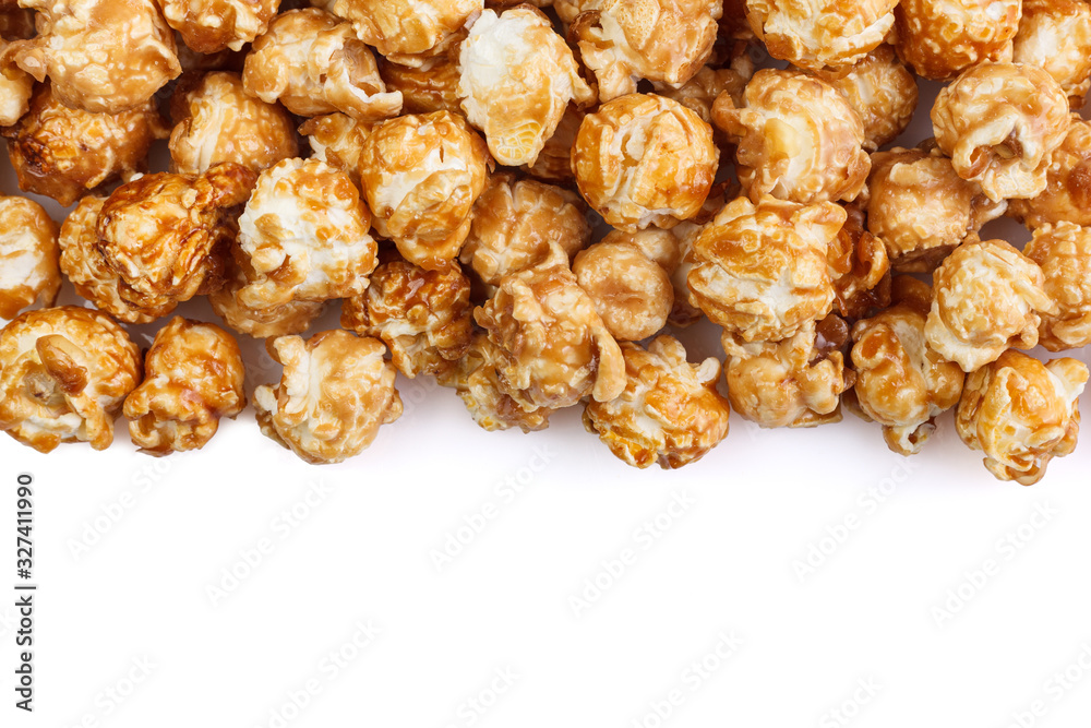 Heap of delicious caramel popcorn, isolated on white background. Scattered popcorn texture background . Selective focus. Heap of delicious caramel popcorn, isolated on white background. Scattered popcorn texture background . Selective focus.