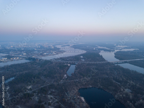 Aerial drone view. Sunrise over the Dnieper in Kiev. On the horizon is a river and bridges.