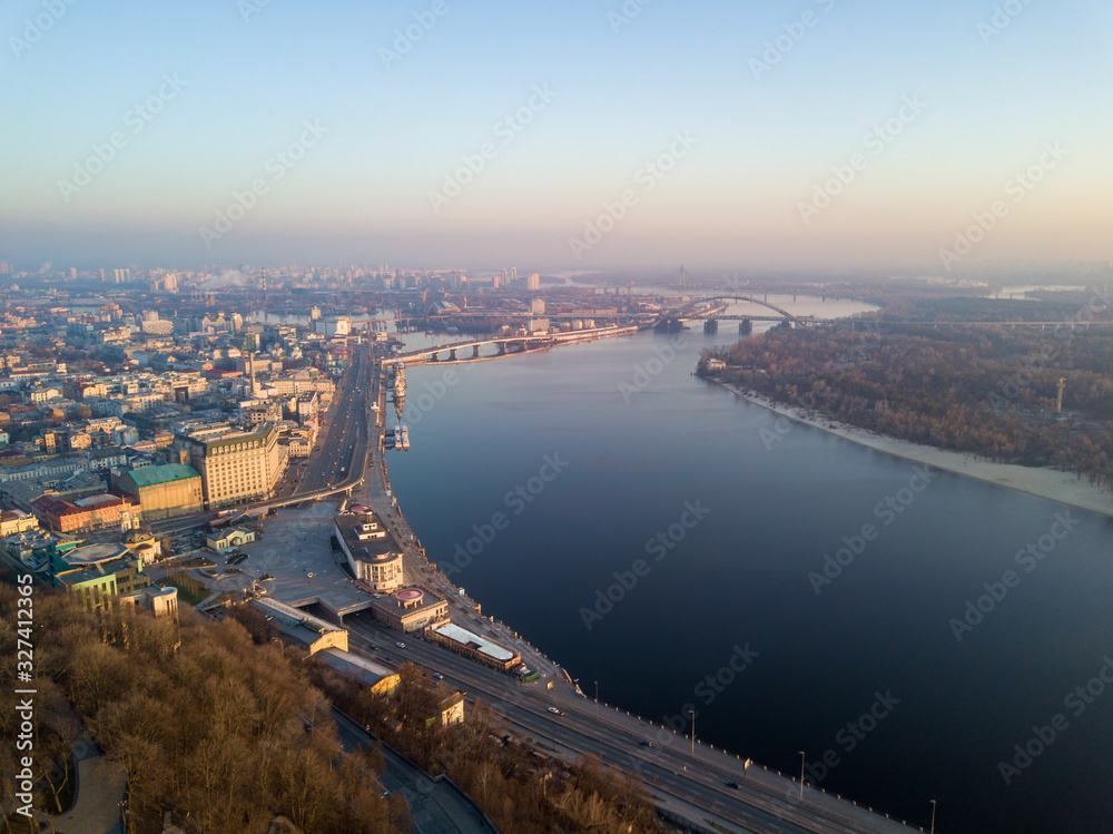 Aerial drone view. View of the Dnieper River and the Podil district in Kiev in the early morning.