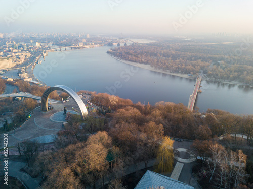 Aerial drone view. View of the Dnieper River, Trukhanov Island and a pedestrian park bridge. photo