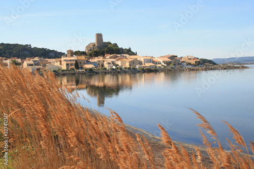 The old town of Gruissan in the heart of Regional Natural Park of Narbonne, dominated by its castle, the ruins of the Barberousse tower and its small fishermen's houses, Aude, France photo