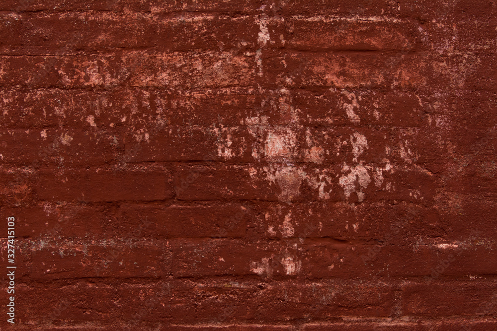 Obraz premium Brick wall painted in terracotta color. Traces of old paint. Wall of a very old european house. Textured surface.