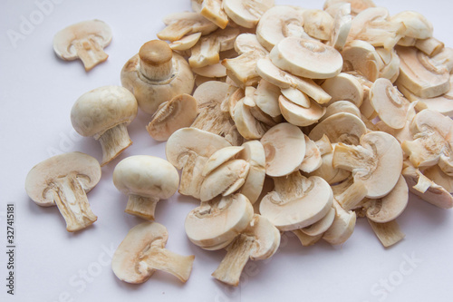 Raw fresh cut mushrooms at white background of the table