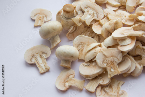 Raw fresh cut mushrooms at white background of the table