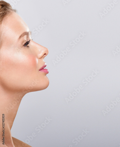 Beautiful face of young adult woman with clean fresh skin.