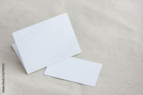 mockup, template with an empty white cardboard postcard and a business card.
