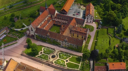 Aerial view of the monastery Bronnbach in Germany. Round pan to the right with wide view of the monastery and front garden. photo