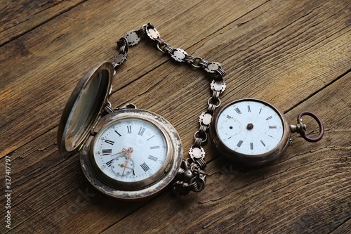 vintage silver pocket watch, old wooden background