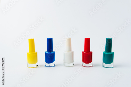 colored nail polishes on a white background