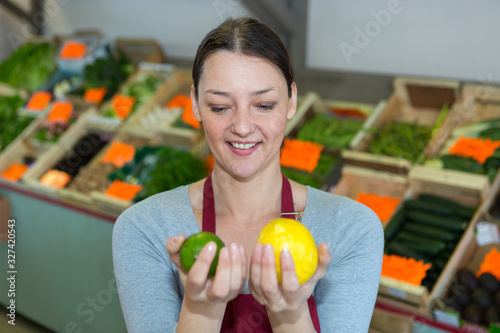 smiling woman choosing fruits on the store