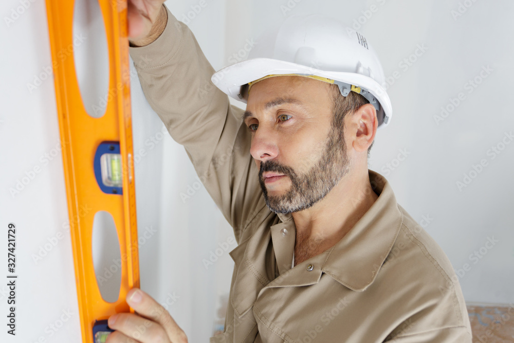 engineer in helmet looking at the level of the profile engineer in helmet looking at the level of the profile