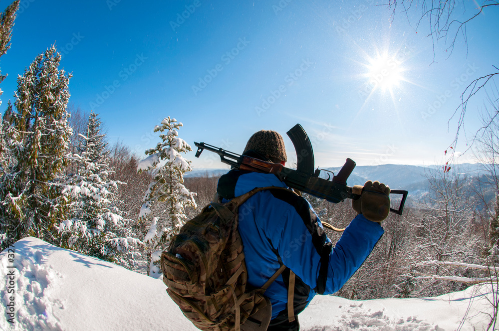 hunting with weapons in the mountains on a sunny winter day