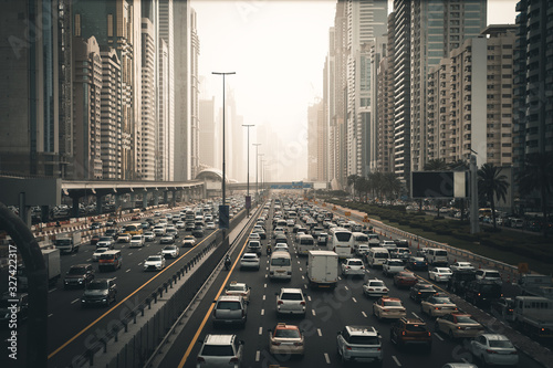 Rush hour with many cars on Dubai city road, traffic jam in downtown.
