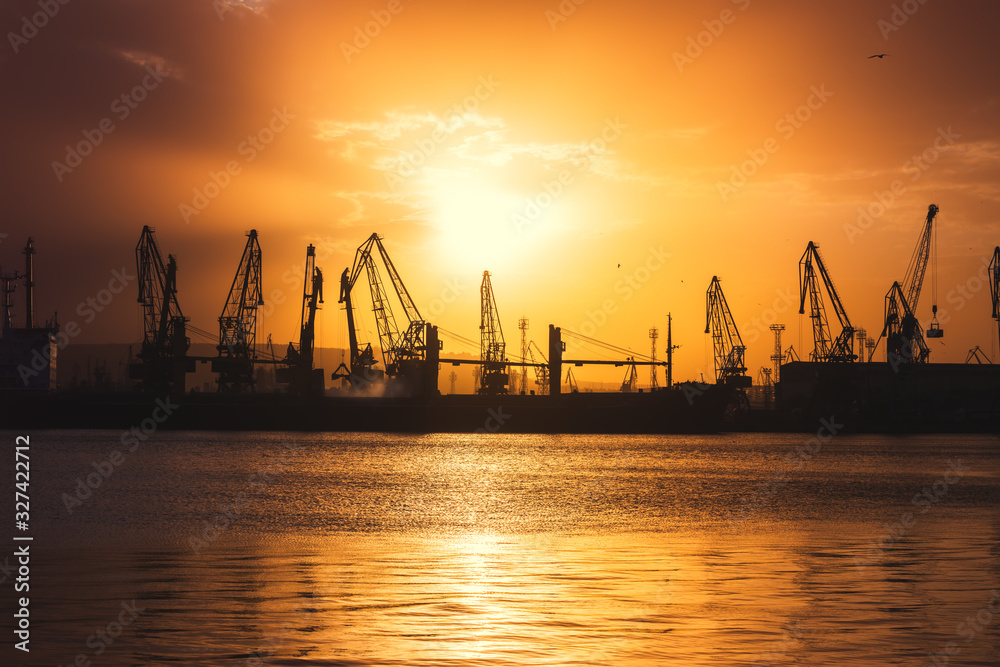 Sea port and industrial cranes, Varna, Bulgaria.Sunset over the Varna lake Sea port and industrial cranes, Varna, Bulgaria.Sunset over the Varna lake