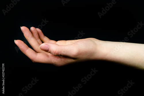 Hands on a black background show various action