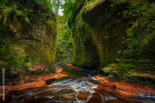 Inside of the Devil’s Pulpit gorge, with running water, Dumgoyne, Scotland, UK photo